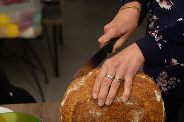 woman cutting a loaf of freshly baked homemade bread 1