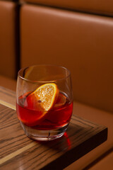 Negroni cocktail at a rustic bar. 