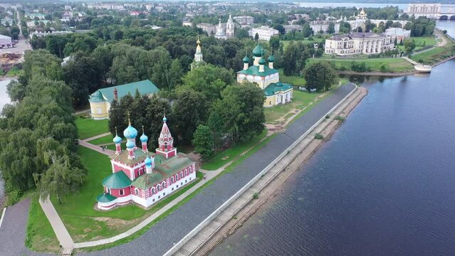 Summer aerial view of modern Uglich cityscape overlooking architectural complex of Kremlin with Transfiguration Cathedral and Church of Dimitry Tsarevich on bank of Volga, Russia