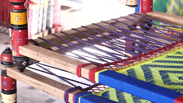 sideways footage with detail of tools used for traditional hand sewing in Pakistan