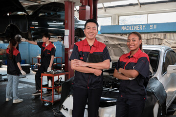 Portrait of professional mechanic partners arms crossed and look at camera, work at car service garage, happy maintenance jobs, check and repair engineer occupation in automotive industry business.