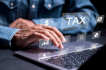 Person use laptop with virtual TAX icon for calculates income to pay taxes to the government. Paying taxes. Filing online tax return form for payment. Calculation tax return taxes and VAT.