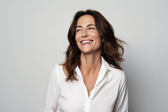 Portrait Of A Beautiful Smiling Business Woman In White Shirt, Isolated On Gray Background