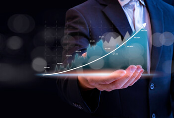 Businessman showing growing virtual holographic stock,positive indicators, businessman calculates...
