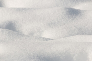 Fototapeta na wymiar Mounds of freshly fallen white snow winter background