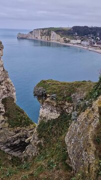 Wonderful vertical view to the Etretat village and beach resort from the famous Falaise d'Aval cliffs in Normandy, France, Europe