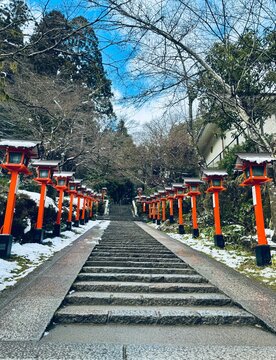 The beginning of the hiking trail in the snowy forest to the Kuramadera Temple at Kyoto, Japan on a winter day 