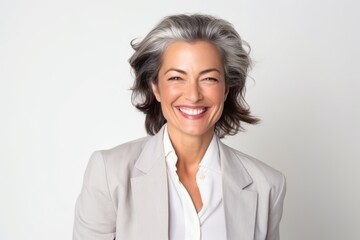 Fototapeta premium Portrait of a happy senior business woman smiling at the camera on grey background