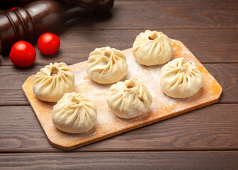 Buuzy, frozen manti. On a wooden background.