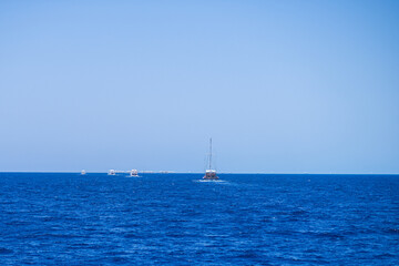 Sailing lboat at open sea in sunshine