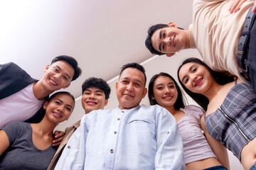 6 young interns posing with their boss. Low angle shot. Startup company showing solidarity and...