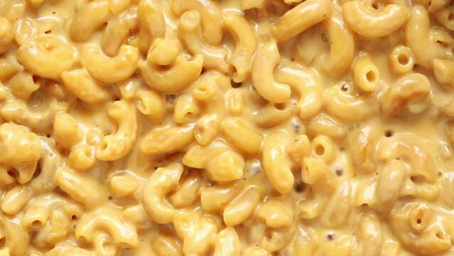 Boiled Macaroni and Cheese Sauce Cooking in a Pan. Top view