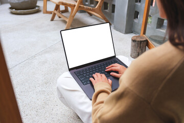 Mockup image of a woman working and typing on laptop computer with blank screen