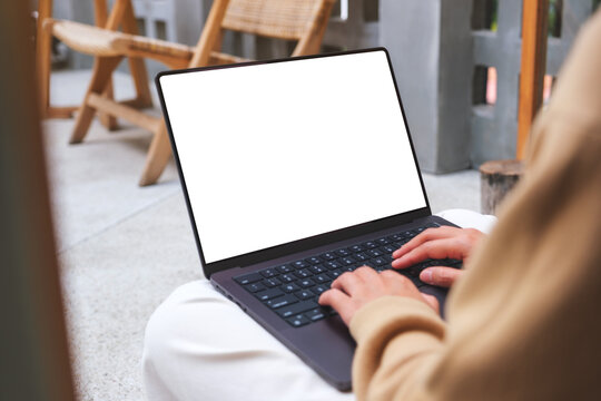 Mockup image of a woman working and typing on laptop computer with blank screen