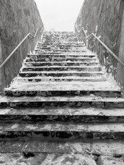 Steps on the stairs in the snow in winter