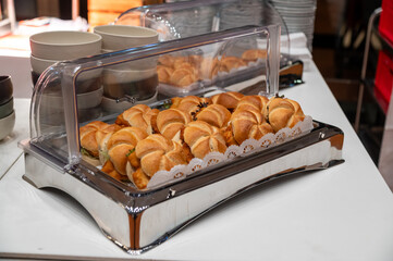 many rolls filled with panned cutlets at a buffet
