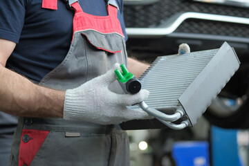 Major repairs of the car. Radiator replacement. An auto mechanic performs quality control of a new...