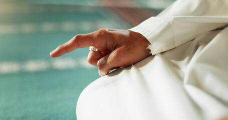 Islam, floor and closeup of a pointing finger or person at a mosque for praying, hajj or support....