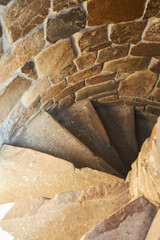 Spiral staircase, descent from a high stone tower