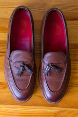 Closeup Upper View of Two Pair of Traditional Formal Stylish Brown Pebble Grain Tassel Loafer Shoes