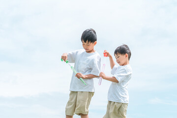 公園でシャボン玉で遊ぶ子供（ピクニック・キャンプ・アウトドア）
