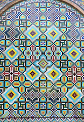 Detail of traditional persian mosaic wall with ornament of blue, dark blue and yellow color, Iran. Colorful geometric mosaic in arch, Tehran