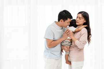 Naklejka premium father and mother holding and hugging with toddler baby on white window background. happy family