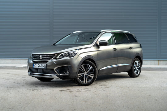 Cluj-Napoca, Cluj-Romania, 12.02.2024 - Peugeot 5008 2018: 7-Seater SUV in Green Metallic Paint, Isolated in Empty Parking Lot, Big Alloy Wheels, 4WD
