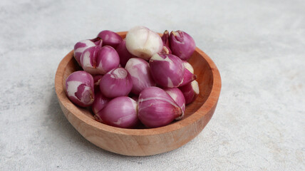 shallot onions on the wooden bowl isolated on grey background. red onion