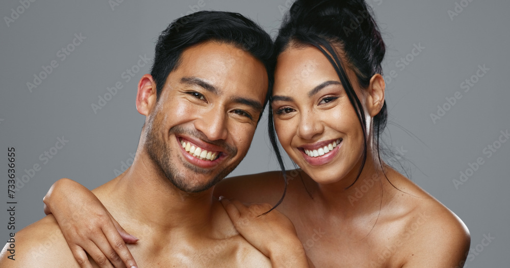 Sticker Couple, smile and care for skincare, love and portrait with moisturizer in studio by gray background. Happy people, dermatology and hug for cosmetics, hydration and creme or happy for skin treatment