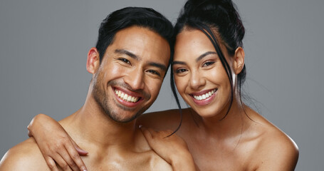 Couple, smile and care for skincare, love and portrait with moisturizer in studio by gray...