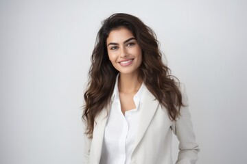 Portrait of a smiling businesswoman with long wavy hair.