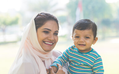 Mother and baby son lifestyle moments in Dubai. Young woman with her kid outdoor. Family concepts in the UAE