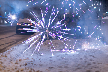 Burning Firecracker with Sparks. Loud and Dangerous New Year's Entertainment. Hooliganism with Pyrotechnics. Noise of Firecrackers in Public Places - obrazy, fototapety, plakaty