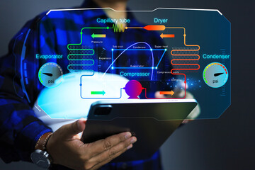 Engineer using tablet to monitor air conditioning system through application interface such as...