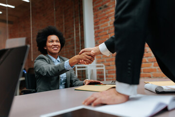 Colleagues shaking hands after striking a deal