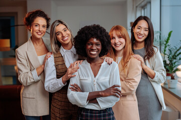 Team of diverse businesswomen posing together and laughing