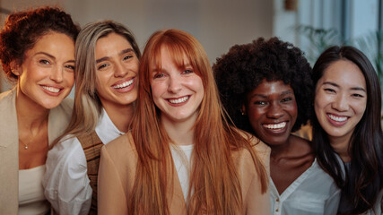 A portrait of five smiling businesswomen in their office - 733654642