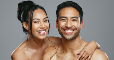 Couple, smile and care for skincare, happy and portrait for wellness in studio by gray background. Happy people, dermatology and hug for cosmetics, hydration and glow or love for skin treatment © HockleyMedia/peopleimages.com