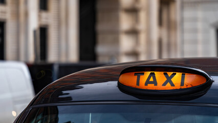 Fototapeta premium Taxi with it's sign on ready for hire