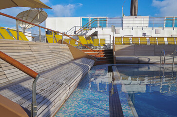 Deck chairs or sun loungers on balcony or terrace or patio pool deck of luxury modern cruise ship...