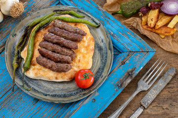 Grilled burgers on the pita bread named cevapi , souvlaki , şiş or inegöl köfte