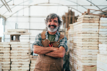 Farmer senior man working in his farm and greenhouse - 733664255