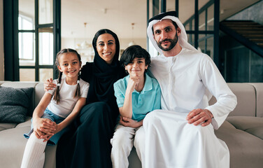 Traditional arabian family from Dubai spending time together at home - 733665641