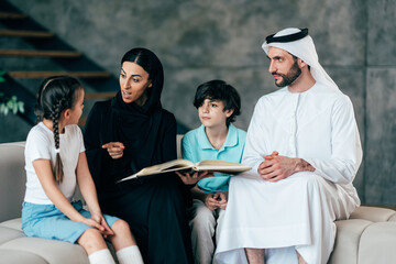 Traditional arabian family from Dubai spending time together at home - 733665655