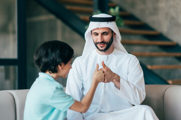 Traditional arabian family from Dubai spending time together at home - 733665679