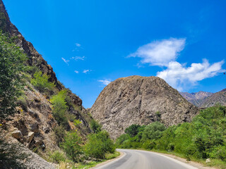 Mountain road along a beautiful plateau between mountain ranges. An untrodden path full of adventures and beautiful views.