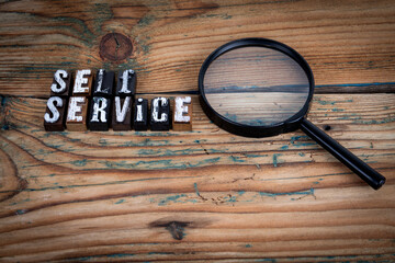 SELF SERVICE. Alphabet letters on wood texture background