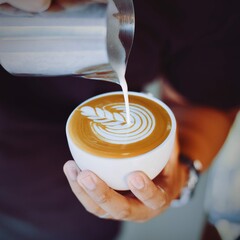 Person Serving Cup Coffee With Metal Jug 2