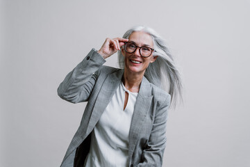 Beautiful senior woman posing on a corporate business  photo session.